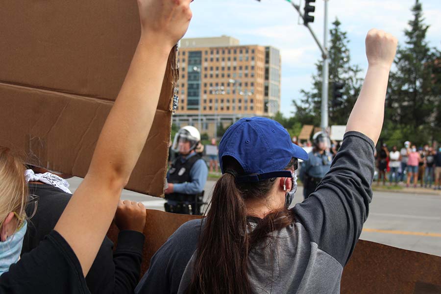 A protester holds up her fist in solidarity with the Black Lives Matter movement during the protest against police brutality at the Country Club Plaza on May 30. 