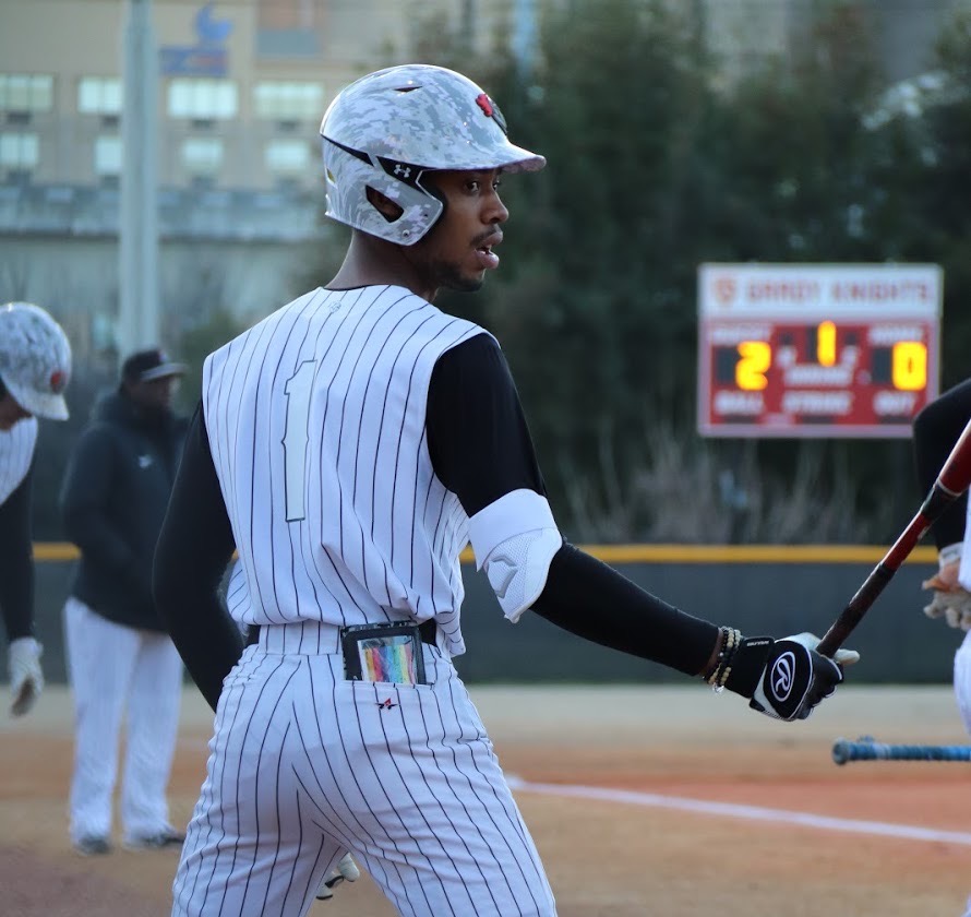 Senior outfielder Christian Smith prepares to step up to the plate in a game.
