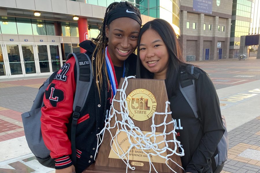 Holding the UIL 5A state championship trophy, MVP of the tournament Jazzy Owens-Barnett  and Kayla Pernis (left) stand outside the Alamodome after the Redhawks claimed the first basketball state title in Frisco ISD history. But the team didnt get to celebrate the win when they got back to school as the COVID-19 pandemic forced all students to virtual learning just days after the state championship. 