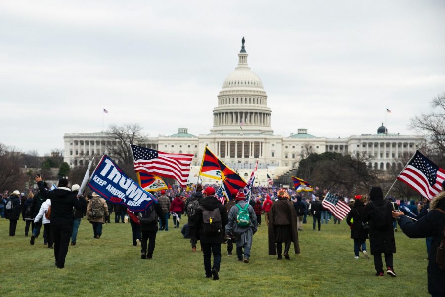 Rioters+with+flags+march+toward+the+Capitol+Building+early+afternoon+on+Jan.+6.+