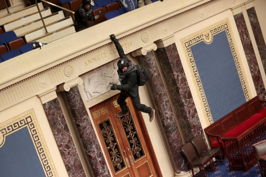 A+protester+is+seen+hanging+from+the+balcony+in+the+Senate+Chamber+on+January+06%2C+2021