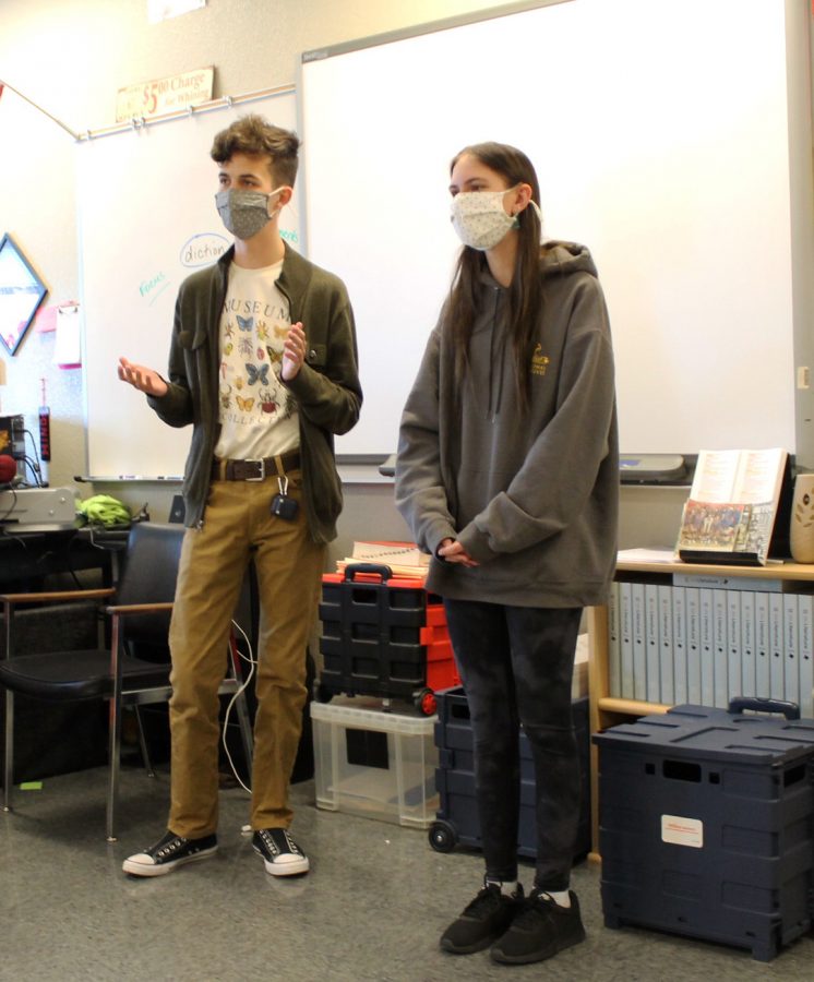 Juniors Daniel Rounds and Karli Robertson wear masks while giving a persuasive presentation in Dondi Hinds English class March 9.