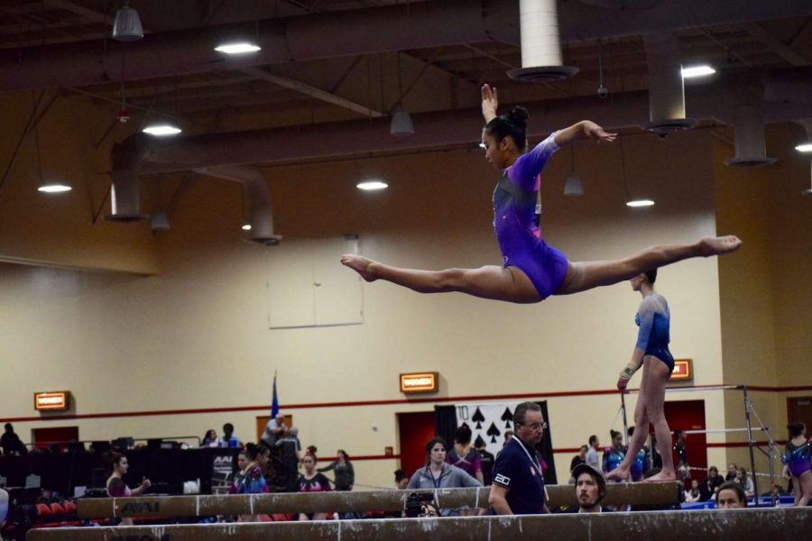 Soaring to new heights: 
Ayumi Oshiro flies across the balance beam at a gymnastics competition. 