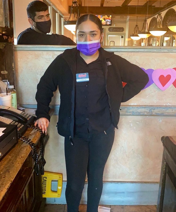 Senior+Lizbeth+Gonzales+stands+at+the+entrance+of+Molina%E2%80%99s+Cantina+during+a+break.+She+works+a+nine-hour+shift+five+days+a+week++to+help+herself+and+help+her+mom+financially.+