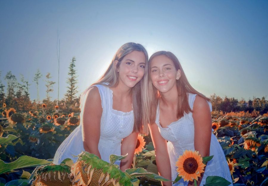 Senior+identical+twins+Allison+and+Julia+Laudato+capture+a+moment+in+the+Prayers+from+Maria+sunflower+field+in+Avon.+Although+they+may+look+similar%2C+they+have+different+future+paths.+%28Photo+courtesy+of+Pauline+Dierkens%29