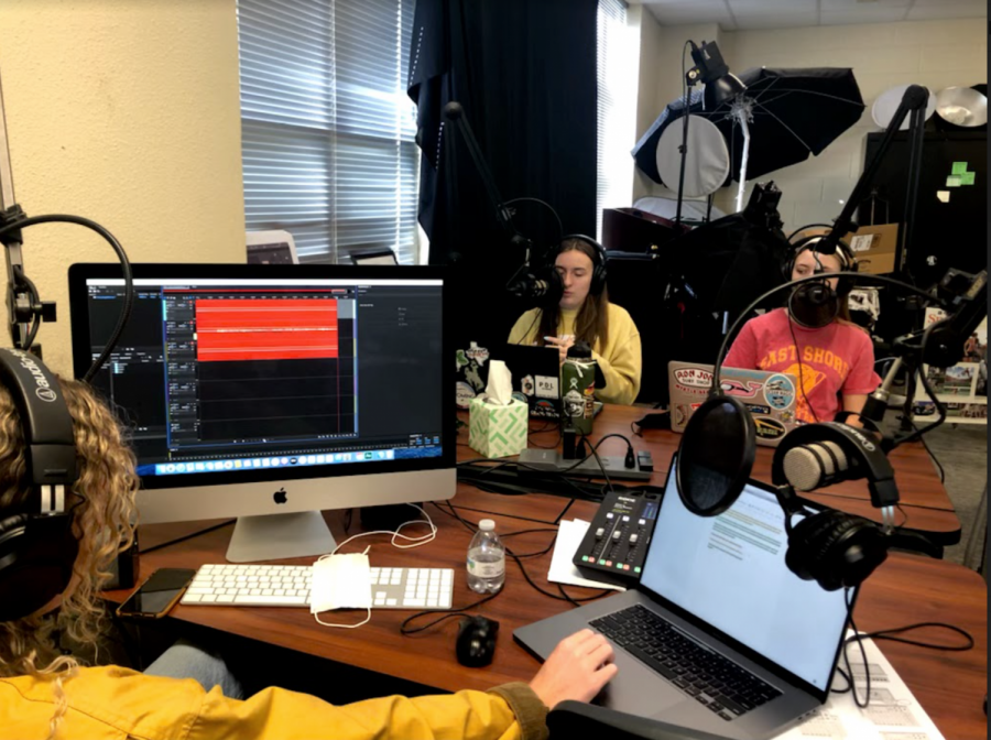In an image taken by journalism advisor, Lisa Roskens, seniors Caroline Wilburn, Emma Hutchinson, and junior Christi Norris record the latest episode of History's Forgotten. In this episode, the team discusses the history of Earth Day, held on April 22. Started in 1970, Earth Day began as a way to educate students about the planet. 