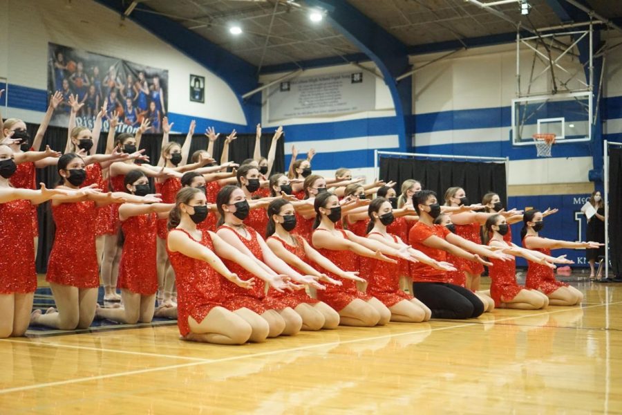 STICKING WITH TRADITION: The McCallum Blue Brigade sticks the final pose during Last Dance to conclude their first Spring Show of 2021 on Friday April 16. “My favorite dance is ‘Last Dance’ because its such a classic!” junior member Natalie Dean said. I think it’s so fun, happy and a great way to end spring show every year,” The routine is full of memories for members past and present as it has been performed at the end of every spring show since 1991. Speaking of traditions, Dean helped to keep another spring show tradition alive when she made a slide show that included photos from the season as well as a tribute to seniors that included current and baby pictures of each graduating dancer.  Reporting by Grace Nugent.