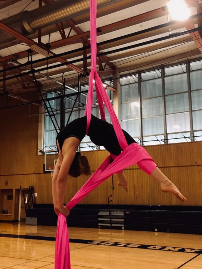 Senior+Cici+Bailey+hangs+upside+down+while+practicing+her+aerial+arts.+Bailey+performs+competitive+aerial+arts%2C+and+her+performances+often+require+specialized+costumes.+There%E2%80%99s+times+where+I+love+my+costume+and+then+there%E2%80%99s+times+where+I+despise+my+costume%2C+Bailey+said.+Sometimes+they%E2%80%99re+ill+fitting+because+the+sizes+aren%E2%80%99t+made+for+all+body+types%2C+obviously%2C+unless+you+get+a+custom+fit+which+can+be+really+expensive.++