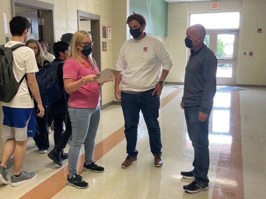 English teachers Erin Smith (left), Andy Lopez and Alex Hollis chat between classes. The strong professional relationships among faculty members have helped Chapman avoid the teacher shortages currently facing the nation.