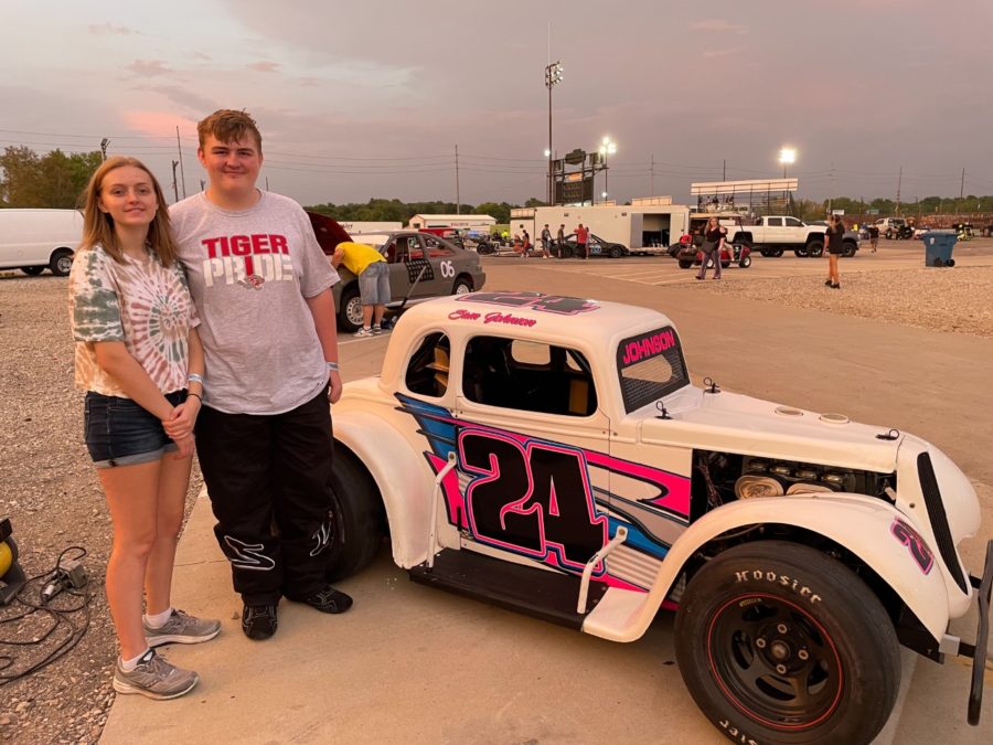 Sophomore Sam Johnson and his sister, senior Natalie Johnson, stand in front of Sam's Legend race car. Sam Johnson is the second youngest driver in his age group (ages 14 to 50.)