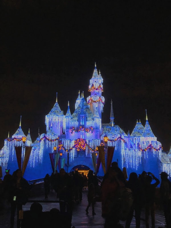 The+Disneyland+castle+dressed+up+for+Christmastime+showing+the+magical+appeal+of+Disney.