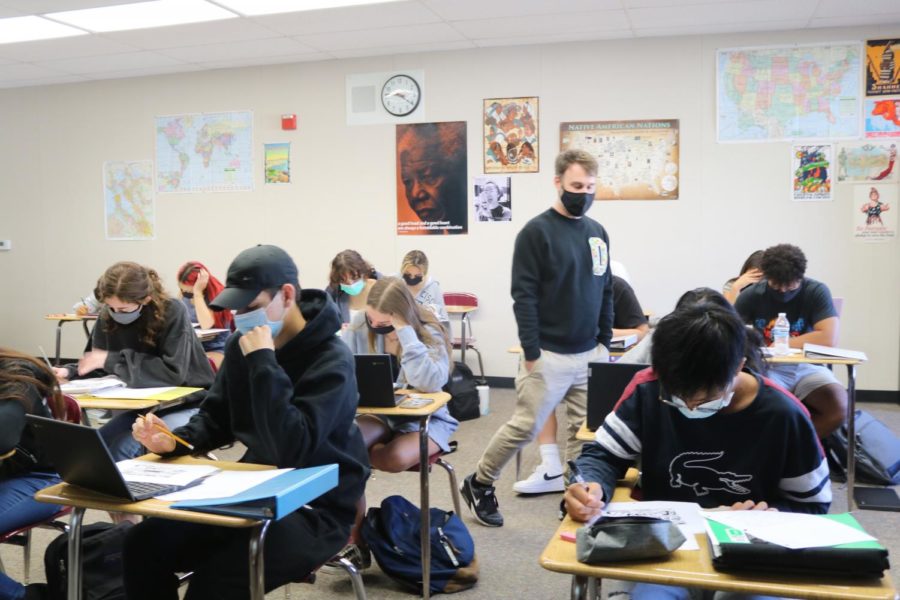 Ethnic studies teacher Benjamin Andersen walks among his students, who are learning about the different histories and cultures of people of color in the first year class.