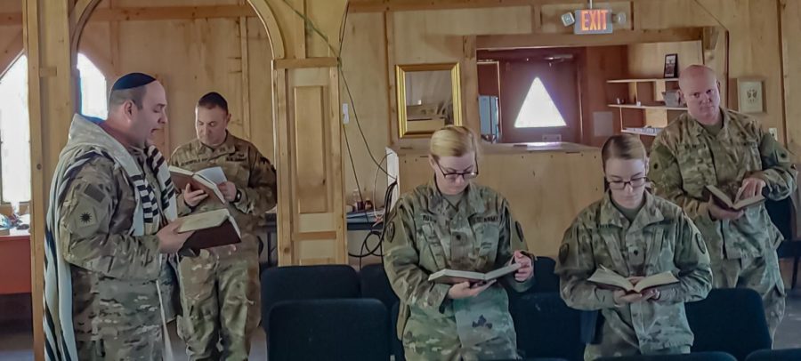 CONNECTED: Jewish service members join together to engage in prayer while deployed in Afghanistan in 2018. U.S. Army chaplain Rabbi David Becker, left, led services for the soldiers, including U.S. Army Maj. Moses Scheinfeld,
second from left; both live in Los Angeles. “I try to lift them up,” said Rabbi Becker, who taught at Shalhevet. “It’s a very difficult time in a soldier’s or military member’s life to be deployed so far from home and everything they know.”