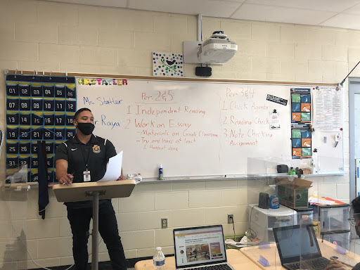 Aaron Raya, classified substitute at Santa Ana Unified School District, takes attendance for AP English Literature teacher, Monique Statlers class, on Friday October 29, 2021, at Godinez Fundamental High School during third period.