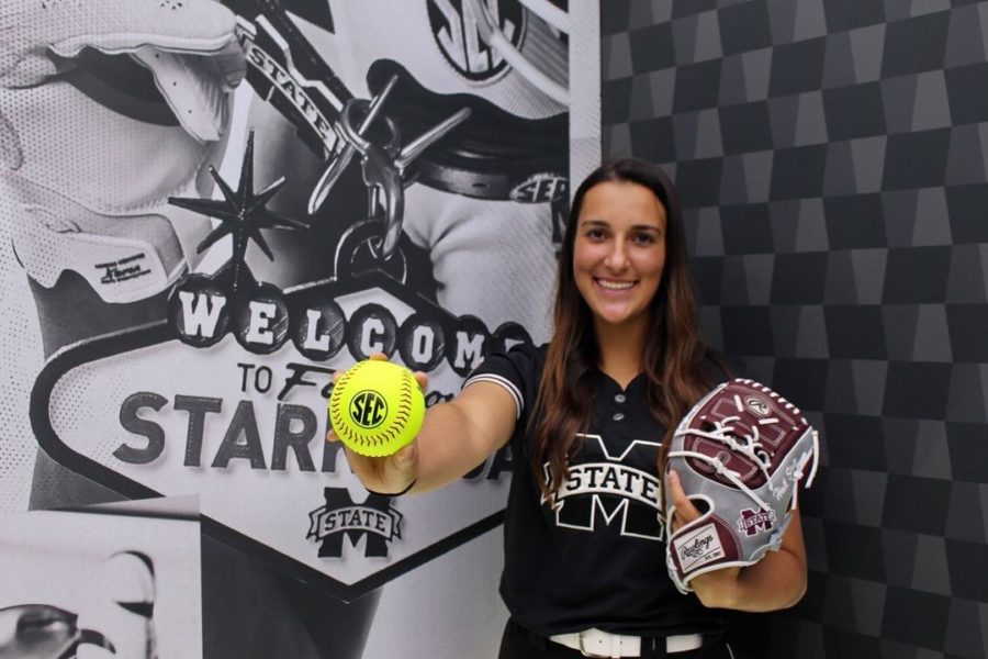 Holding out a softball, senior Gabrielle Coffey stands to take photos for Mississippi State University. Coffey signed her commitment letter to Mississippi State Wednesday, Nov. 10. She plays for the Brazil junior national softball team, as well as the Prosper varsity softball team and Texas Glory.