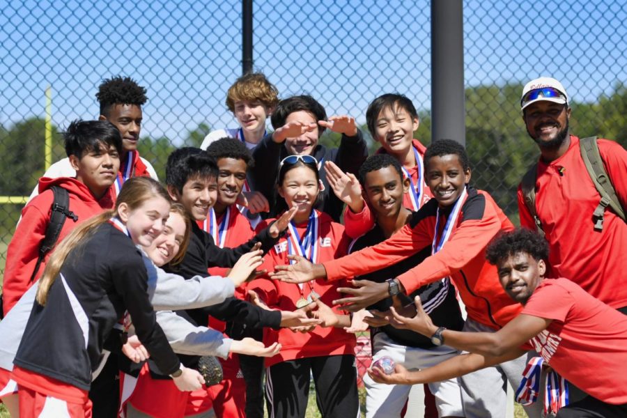 Measho (row 2 right) and the track team pose with their medals in fall 2019 after a meet. Negri, his Principles of Art and AV teacher, said that Measho was very focused on cross country and track.