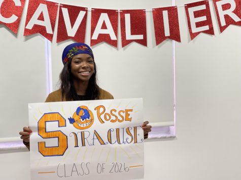 Briell Robinson proudly holds her Syracuse poster as she gets ready to embark on a new academic journey.