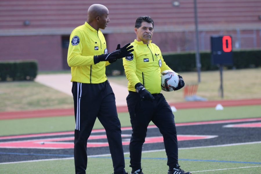 Texas Association of Sports Officials referees Carmichael Willaim and David Leiva talk prior to kickoff between Coppell and San Antonio Reagan at Buddy Echols Field on Jan. 7. Due to a shortage of referees, many matches are only being officiated in duals instead of the typical trios.