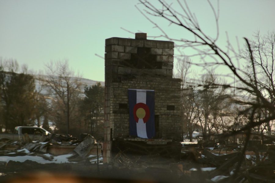 A+Colorado+flag+hangs+on+a+chimney+in+Old+Town+Superior.+The+Old+Town+neighborhood+was+among+a+few+burned+entirely+to+the+ground+in+Superior+and+Louisville%2C+Colorado%2C+in+the+Marshall+Fire%2C+which+swept+Boulder+County+Dec.+30.