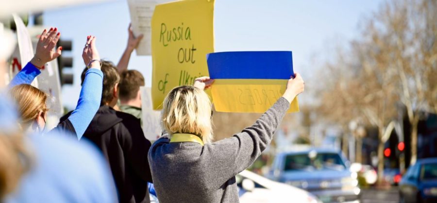 Victoria Kheyfets holds up a poster in the colors of the Ukrainian flag at the Peace Crossroads in San Jose on March 6 in a demonstration advocating for a ceasefire in Ukraine after Russia invaded the country on Feb. 24. Kheyfets family lives in Kharkiv, the second-largest city in Ukraine. 