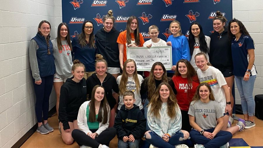 Utica University’s women’s soccer team with a check for ,000 to send Team IMPACT teammate Arianna “Anna” LaBella to Disney World.