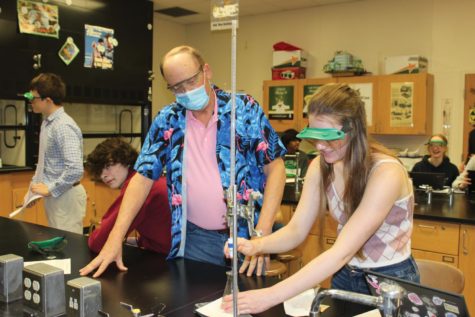 Retiring chemistry teacher Bob Blaus helps his students with their titration lab. 