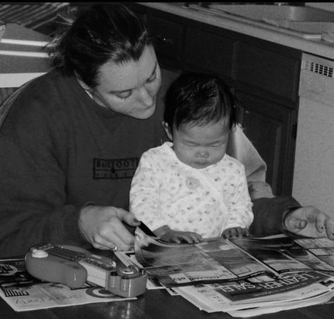 Sandvall and her mom reading the paper at the kitchen table. 