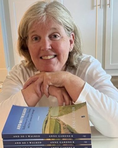 Reverend Anne Gardner smiles as she poses with her debut book, And So I Walked. Her novel focuses on her travels as she journeyed across the Camino, and touches on topics like faith and resilience. 