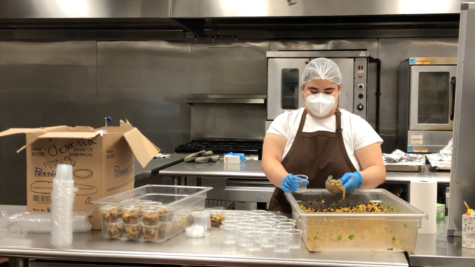 At 9 A.M., a school lunch worker assembles a side of corn, beans, and spices for students to enjoy during lunch.