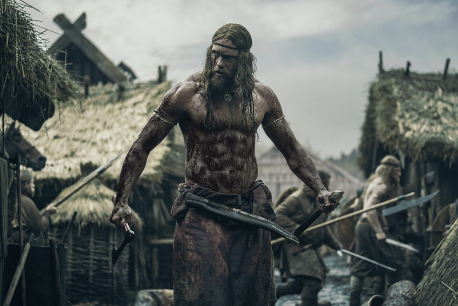 Amleth (Alexander Skarsgård) trudges through battle in Robert Eggers The Northman. The film is now playing in theaters.