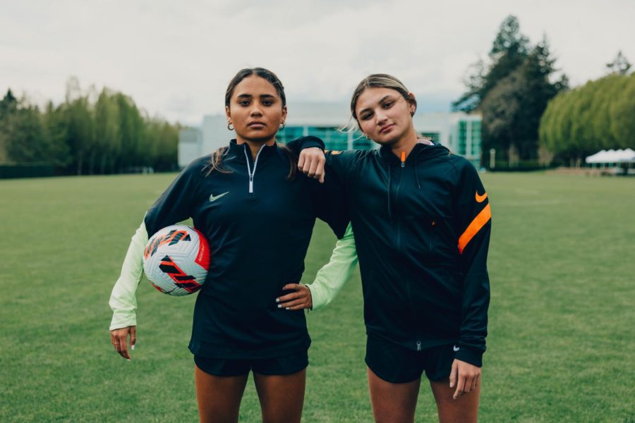 Alyssa+Thompson+23+and+Gisele+Thompson+24+pose+with+a+soccer+ball+wearing+Nike+gear.+The+sisters+are+the+first+high+school+athletes+in+history+to+sign+an+NIL+deal+with+Nike.+
