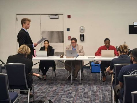 The Student Body Presidents Executive Assistant John Dunn (pictured standing to the left) represents Pi Kappa Alpha in its case against the Interfraternity Council during the Student Court hearing on Sept. 12, 2022.