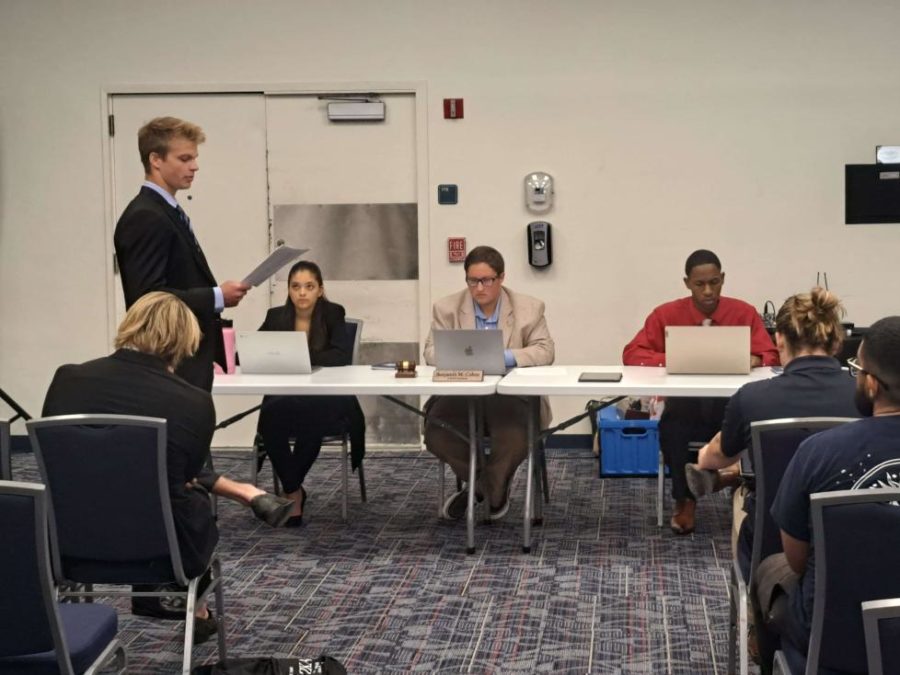 The Student Body President's Executive Assistant John Dunn (pictured standing to the left) represents Pi Kappa Alpha in its case against the Interfraternity Council during the Student Court hearing on Sept. 12, 2022.