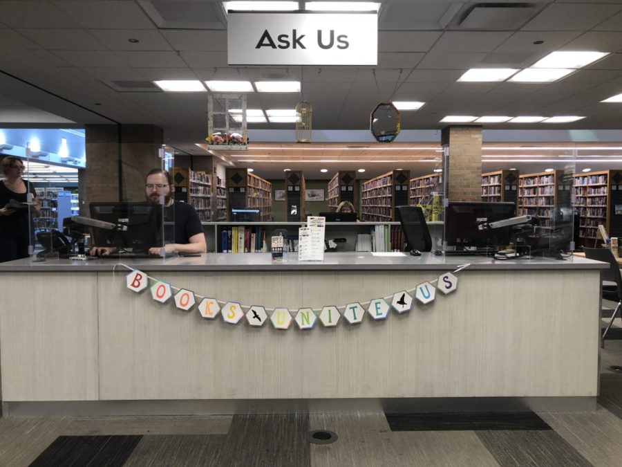 The Downers Grove Public Library displays a sign that says Books Unite Us in support of the canceled Drag Queen Bingo event.