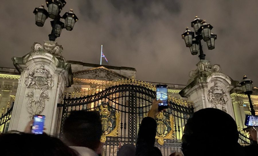 Two+hours+after+the+public+announcement+of+the+Queen%E2%80%99s+death+Sept.+8%2C+crowds+gather+in+front+of+Buckingham+Palace+backdropped+by+a+flag+lowered+to+half-mast.+The+official+notice+from+the+Royal+administration+consisted+of+two+sentences+posted+on+the+gates+as+a+double+rainbow+framed+the+Palace.