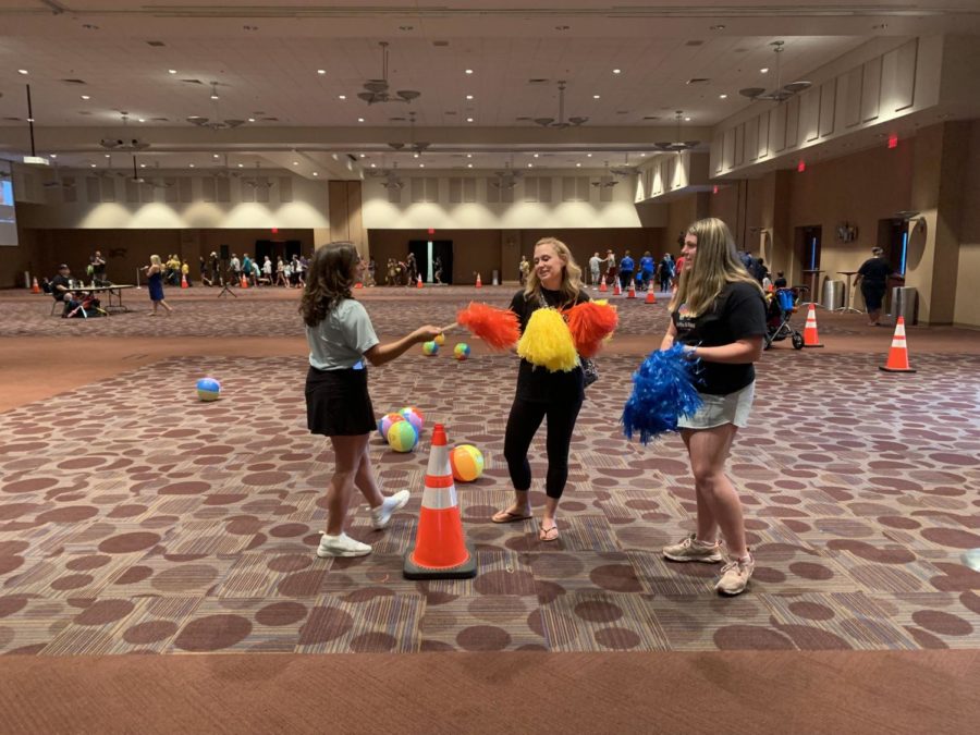 Orange%2C+yellow%2C+and+blue.+Attendees+of+the+Autism+Awareness+Walk+stroll+around+the+second+floor+of+the+Convention+Center.+The+Autism+Community+distributed+pom-poms+in+various+colors+to+the+participants.