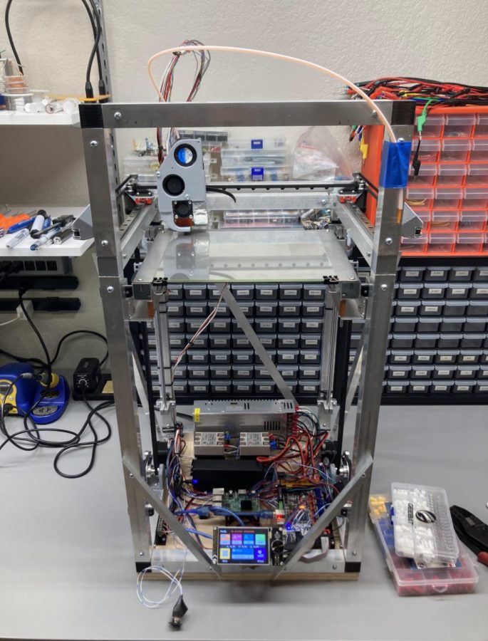 LIGHTING UP: This handmade 3D printer is fully wired to create a variety of objects. Knoepfle worked over the course of nine months in order to perfect his fully functioning machine, and plans to continue building on to it as the school year continues.