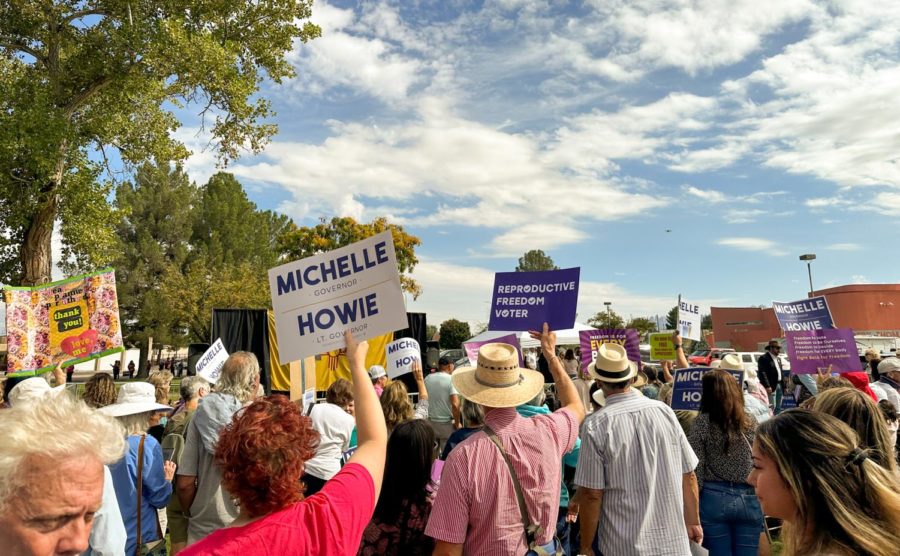 Participants and crowd-goers raise several signs at the Rally for Choice outside Thomas-Branigan Memorial Library on Oct. 15, 2022. 