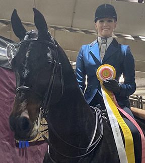 Atop her horse Laing Hill Atha, senior Natalia BarNoy shows off her third place ribbon. There were a total of 20 riders in that class.