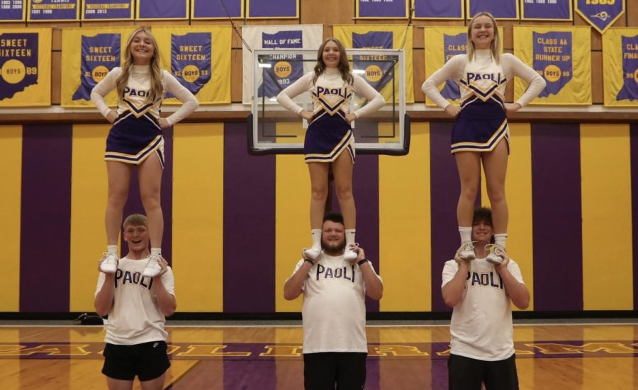 The 2022 Cheer Squad stunts with (from left to right) sophomore Coy Busick with sophomore Taylor Patton, senior Braydon Hayes with junior Harleigh Poe and sophomore Peyton Baker with freshman Tori Patton.
