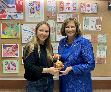 Junior Makenna ford stands with state representative Candy Noble. Ford was selected to create a ornament for the state house chamber Christmas tree.