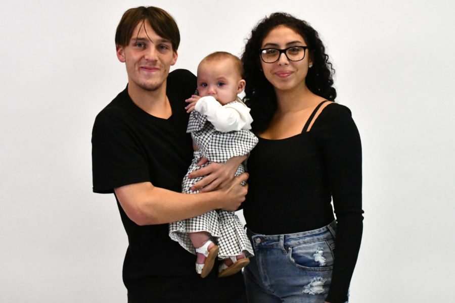 Senior Christian Smith and Lylah Pereira hold their daughter 7-month-old daughter OakLynn. The two parents have fallen into a routine as Smith juggles parenting with finishing his senior year.