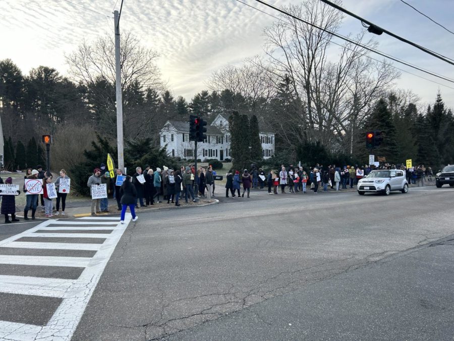 Wayland community members gather along Old Connecticut Path in front of the entrance to Wayland High School. Demonstrators voiced their support of Superintendent Omar Easy following the racist graffiti targeted towards him.
