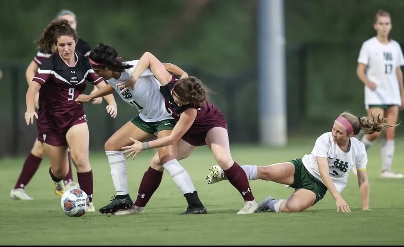 Yaritza Trejo (12) fights for possession of the ball against the Collierville Dragons. While the Spartans put up a tough fight, they ultimately lost the game by a close score.
