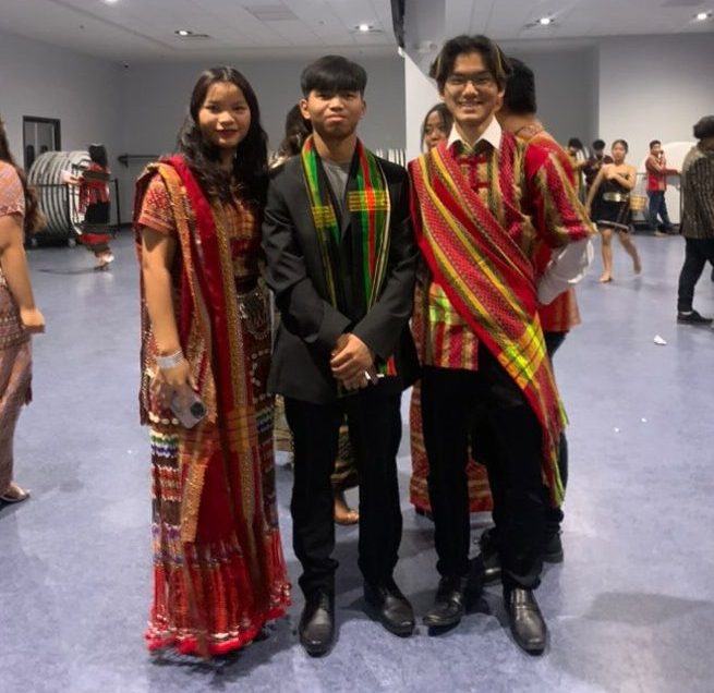 Junior Cherry Iang, Chan Kung and junior Chan Thang pose for a photo wearing traditional Chin clothing during CEBC's Chin National Day celebration on Feb. 18.