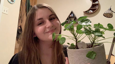 Senior Annie White with one of her favorite plants she owns.