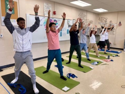 Lonnie Simpson (11), Yousif Hussein (12),  Dylan Heaston (12), Rayleigh Salmon (12),  Cecilia Hatch (12), Ximena Olguin (12) and Nalani Steele (11) pose in the Warrior I/Virabhadrasana I lunging pose that opens up the hips and chest. 