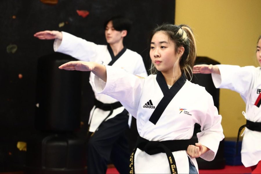 Coppell High School junior Jisu Park practices taekwondo forms at U.S. White Tiger Martial Arts  on Jan. 27. Park explores similar movements such as a front aerial in both dance and taekwondo, combining the two art forms. 
