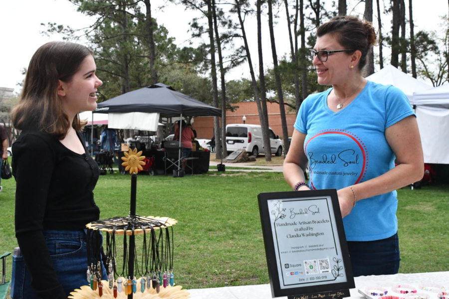 At the Kingwood Farmers Market, sophomore Olivia Brenner catches up with fellow vendor Claudia Washington.