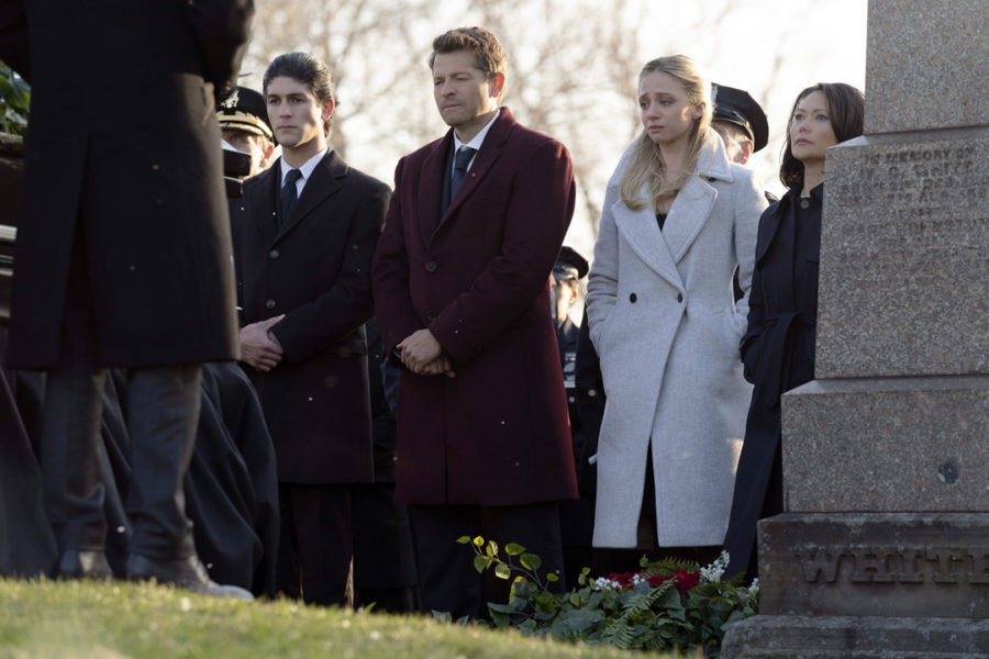 Despite the absence of the Caped Crusader in CW's new series, "Gotham Knights," viewers may get to see the origin story of how the town's district attorney, Harvey Dent (actor Misha Collins, center) eventually turns into DC's famous villain, Two-Face. The prosecutor is joined by others from the community at Bruce Wayne's funeral in the series' pilot episode.